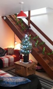 View of Christmas tree and stair garland.